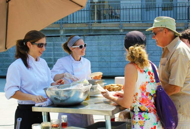 Grace Genter from Atomica serving up some hungry demo attendees. (photo by Julia Segal)