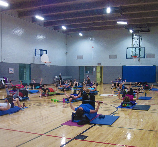 RIP Participants do chest presses while lying back on benches.