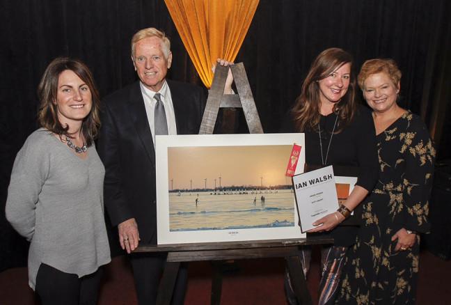 Suzy Lamont, second from right, is awarded $2,500 and has her photo taken with Kingston Life's editor Danielle Vandenbrink, and Kingston Accommodation Partners representatives William J Swan and Heather Ford, after her photo was chosen as the overall winner in the Open Category at the inaugural Ian Walsh Photography Competition award ceremony held in Memorial Hall in Kingston, Ont. on Wednesday February 10, 2016. Julia McKay/The Whig-Standard/Postmedia Network