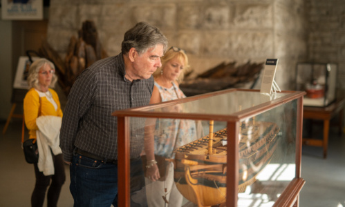 People looking at a boat on display