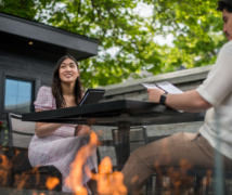 Two people sitting facing each other looking at menus at the Frontenac Club.
