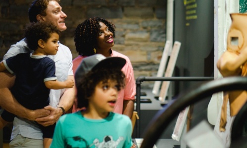 A family looking at an exhibit at PumpHouse Museum