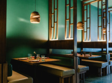 Wooden tables and seating benches inside Miss Bao