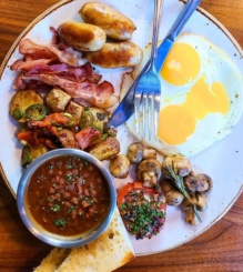 Brunch plate with eggs, bacon, sausage, beans from Dianne's