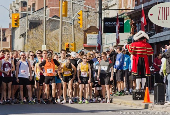 Runners are exhorted to "pray heed the following proclamation" by Town Crier Chris Whyman (right). And then they're off! Photo credit: Carter Brundage