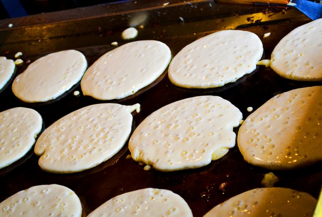 Bubbles form, as pancakes are ready to be flipped.