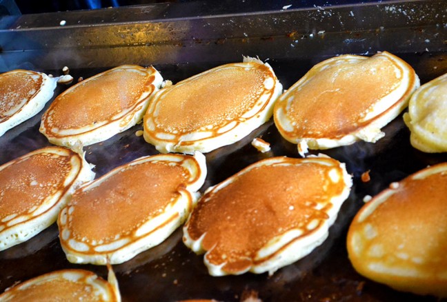 Pancakes sizzle, as they are ready to be served.