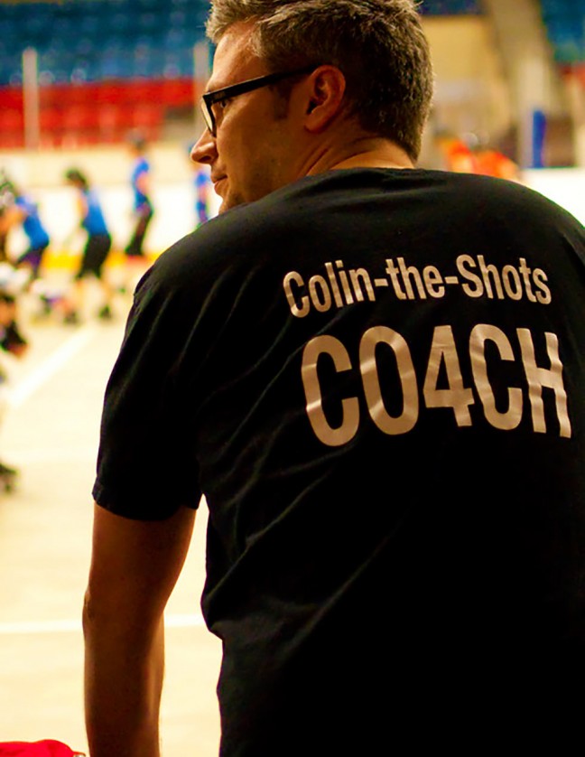 The Skateful Dead Coach “Colin-the-Shots” looks on while the Kingston Derby Girls scrimmage during practice.