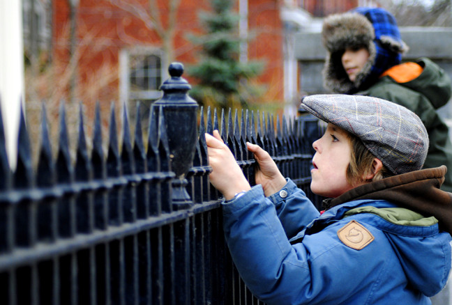 Peering over the fence at the Cartwright house, trying to read the plaque on the wall.