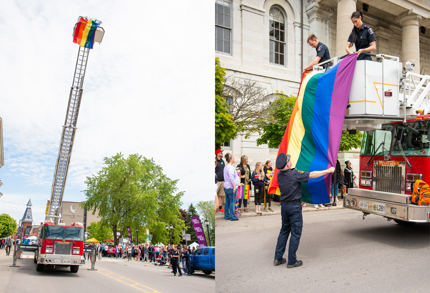 A pride flag is hoisted up on a fire truck ladder in at city hall