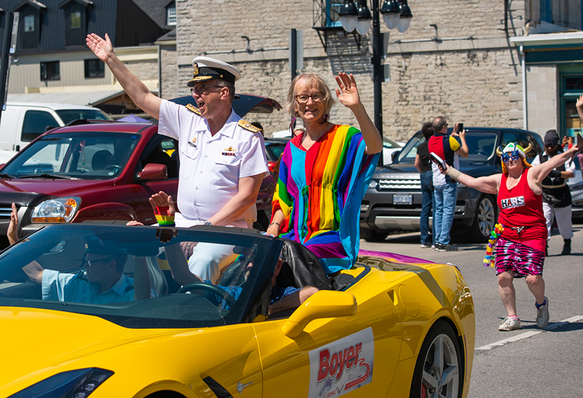 KPI chair Ruth Wood in rainbow dress in yellow convertible