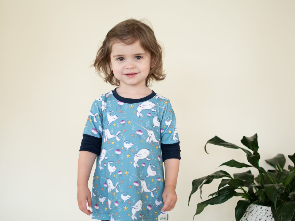 A young customer models a narwhal tunic from Pure Colour Baby’s new collection.